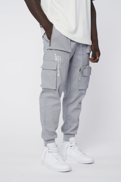 MULTI POCKET REVERSE SIGNATURE CARGO PANTS